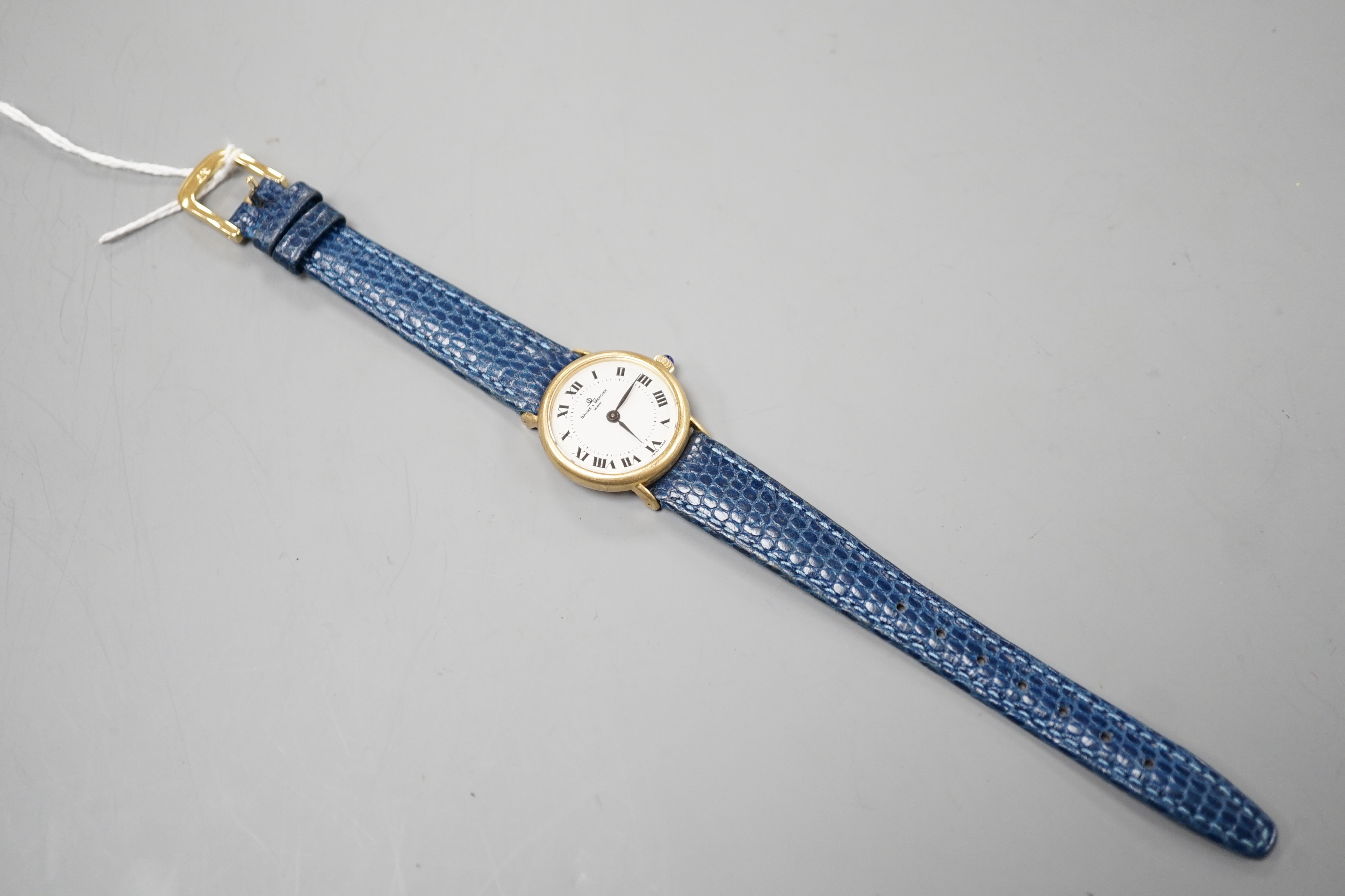 A lady's modern 18k Baume & Mercier manual wind wrist watch, with Roman dial, on associated leather strap, case diameter 24mm.